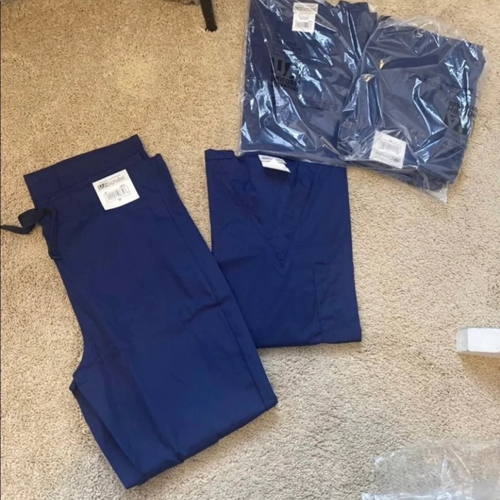 2 sets. Navy blue scrubs.